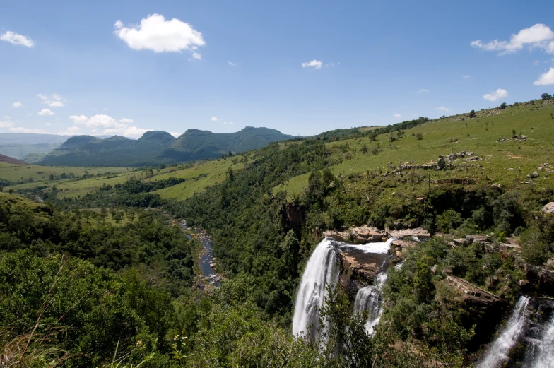 a waterfall is seen in the middle of an open field