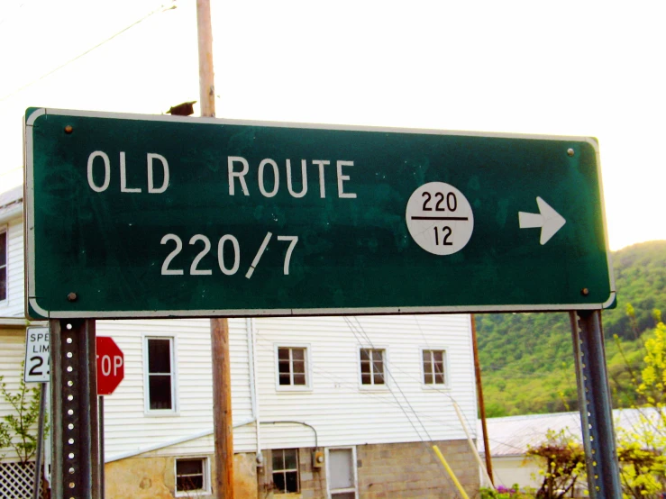 an old route sign is pointing to the right