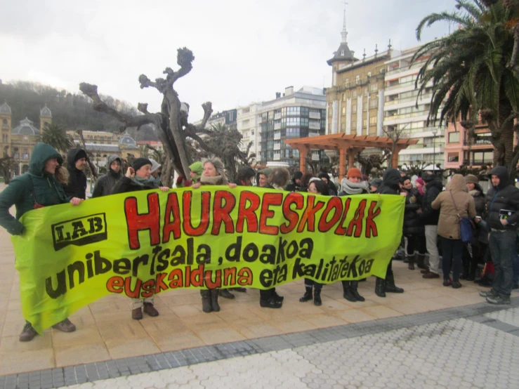 the people are holding a protest sign and protesting