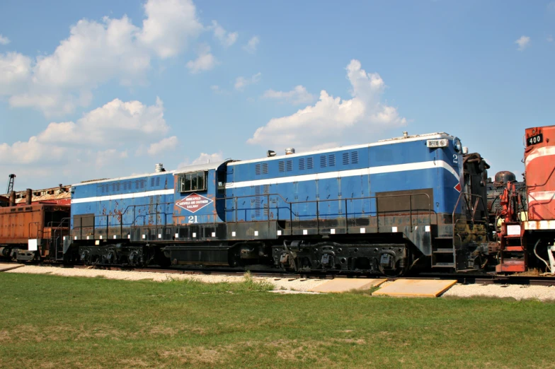 a train traveling on train tracks near a field