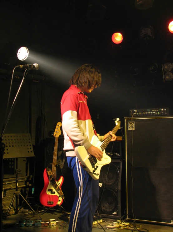 a musician on stage playing with a guitar
