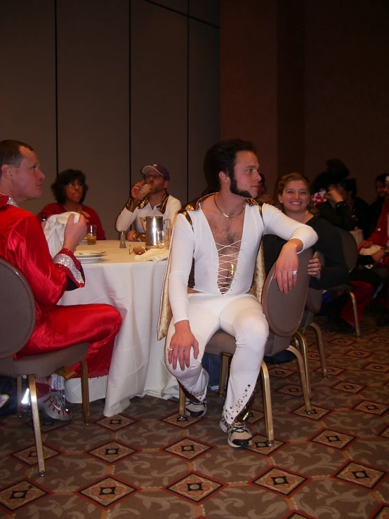 two men in elvis suit at a banquet