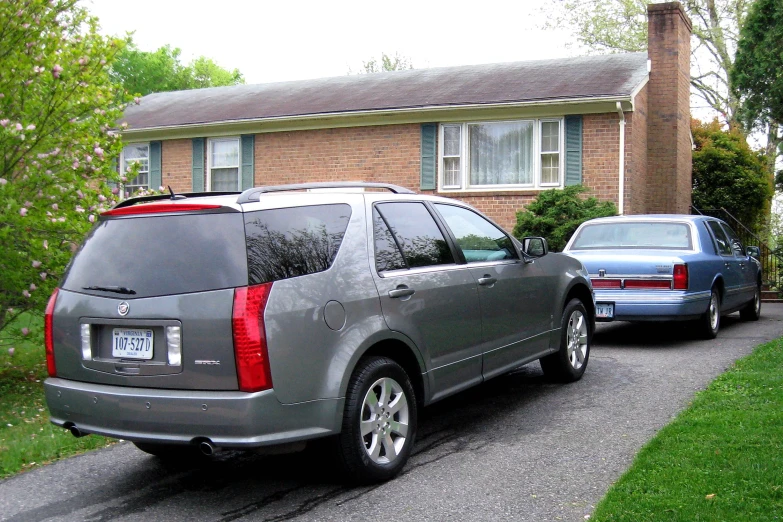 a grey suv parked in front of a house