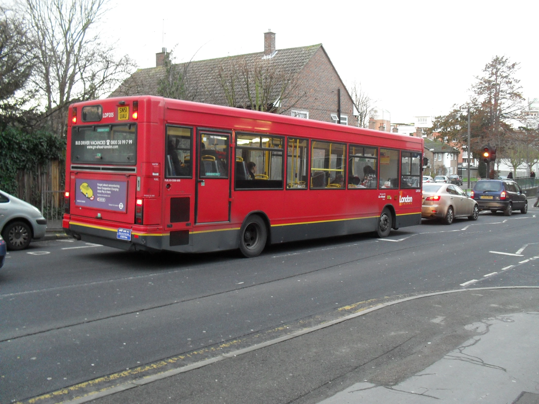 a large red bus on a city street