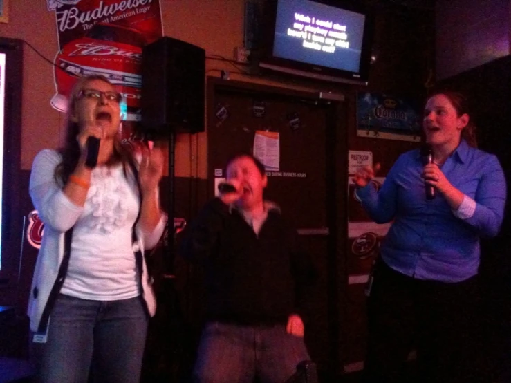 a group of women singing and playing with each other