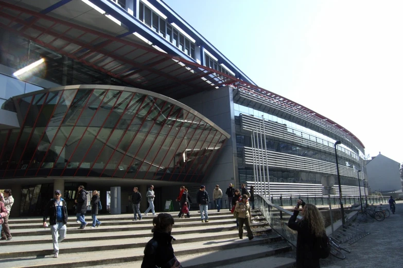 a group of people standing around a staircase near a building