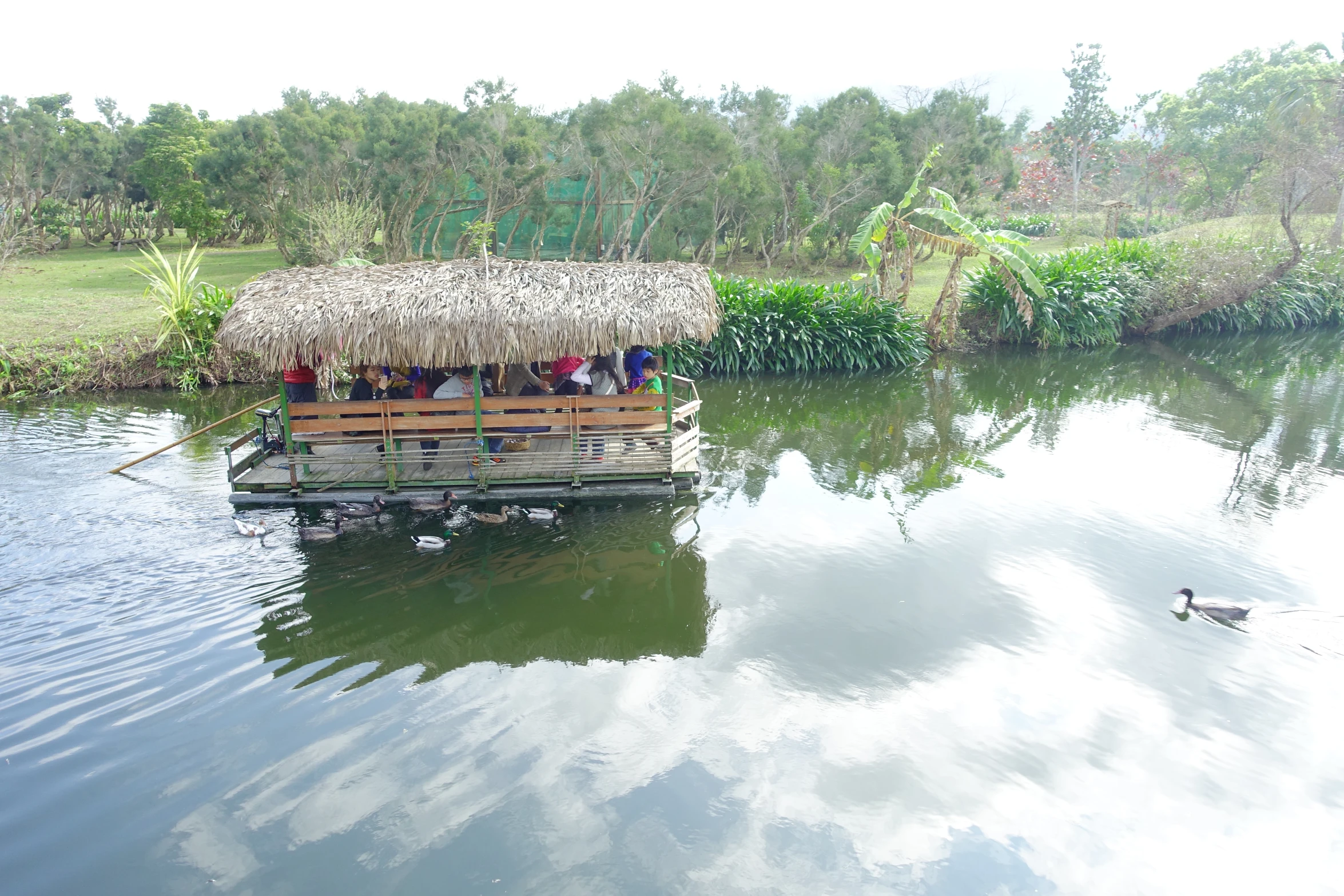 a small boat with people in it is floating near the shore