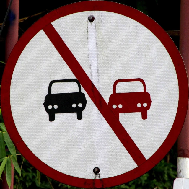 a traffic sign with a picture of two cars on it