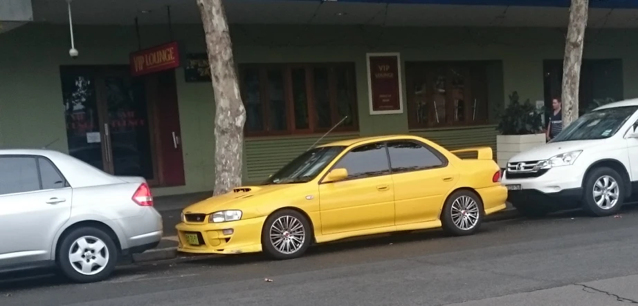 two cars parked side by side in front of a store