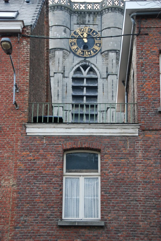 an old brick building with a balcony and a clock