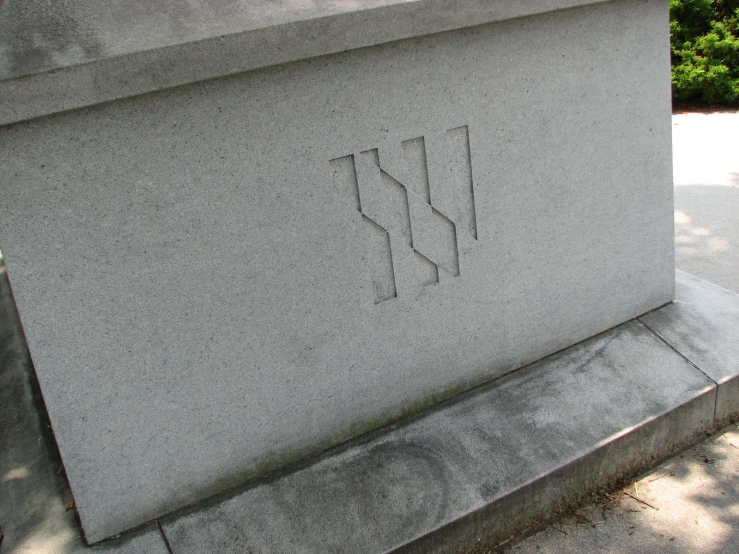 a cement bench with the words w in carved into it