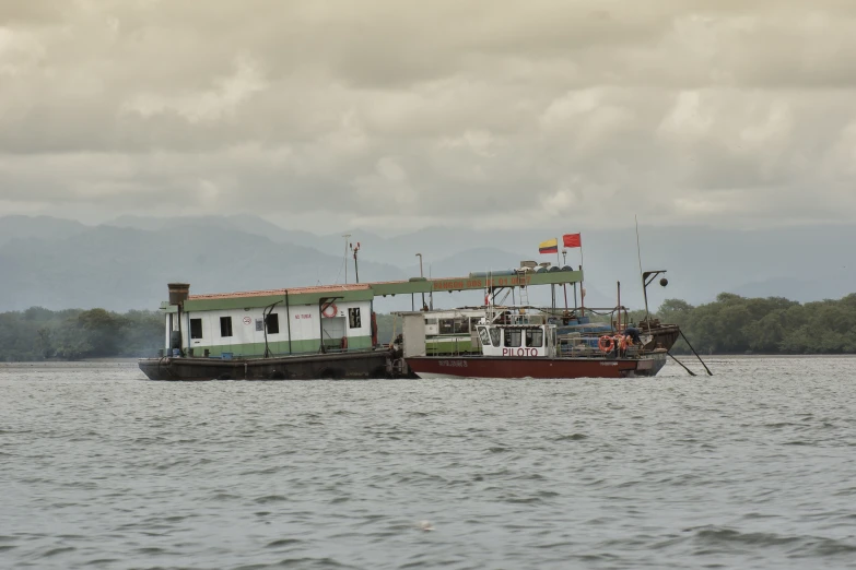 a fishing boat docked near a dock on the water