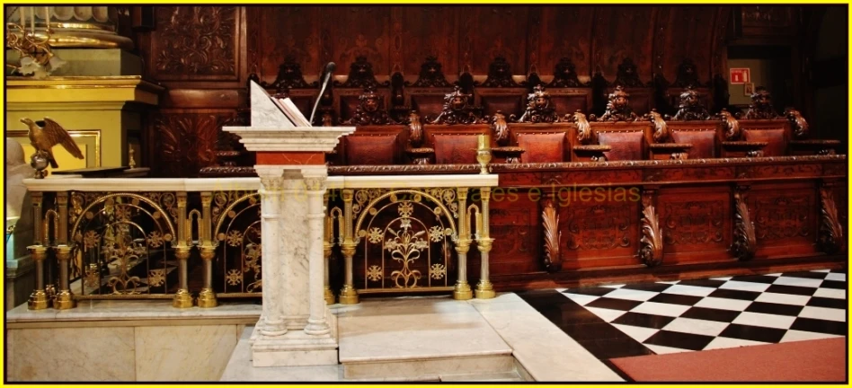 the large ornate and elaborate wooden room is decorated in white marble