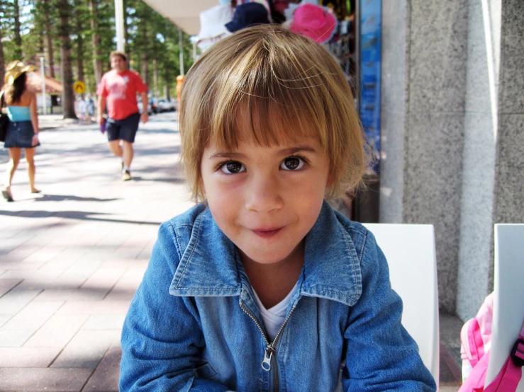 a little girl smiles and stares for the camera