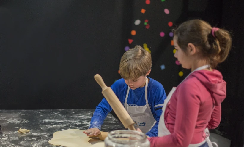 a  and a girl making homemade dough