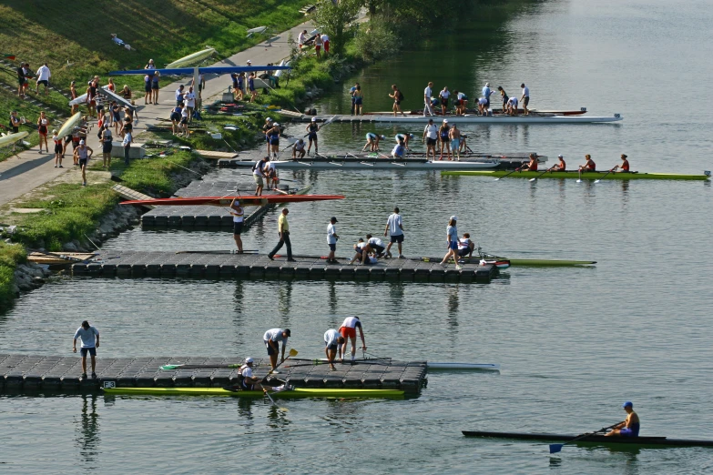 people in canoes on the river rowing along the water