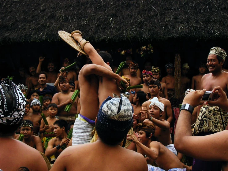 people watching men and women dressed in a festival