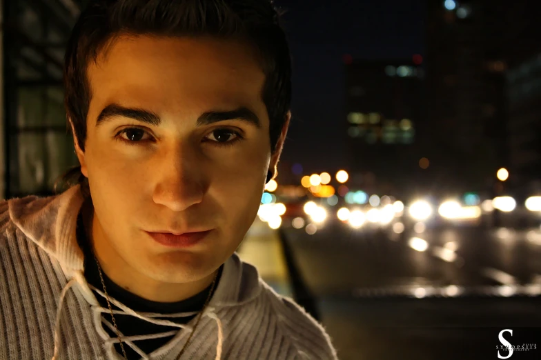 a man with earrings looking towards the camera