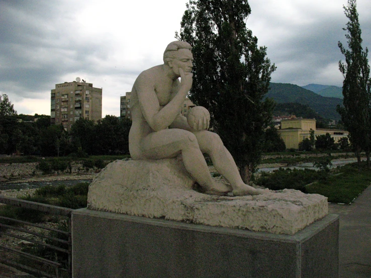 a statue of a man sitting on a bench