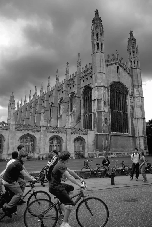 people are riding bikes near an old building