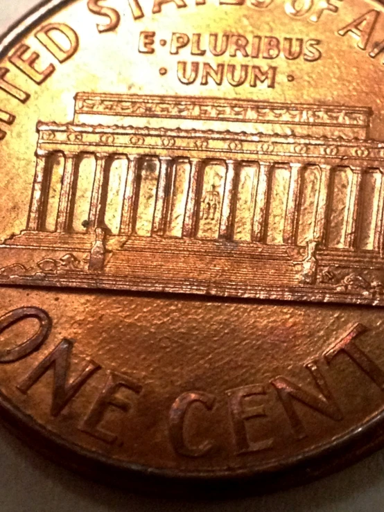 the lincoln memorial, and the lincoln memorial, are depicted in a close up view of the coin