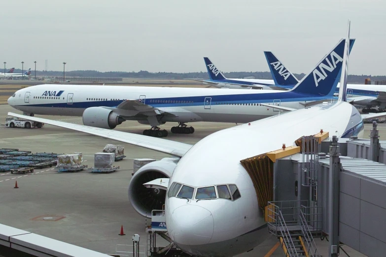 two planes are parked on the tarmac at the airport