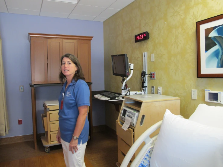 a woman in a hospital room standing near a machine