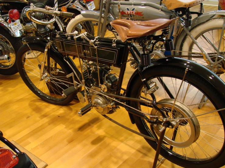 vintage bicycles lined up inside a store near other motorcycles