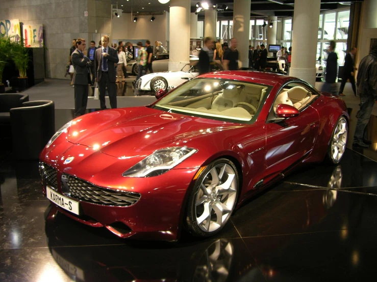 a large red sports car parked in a garage