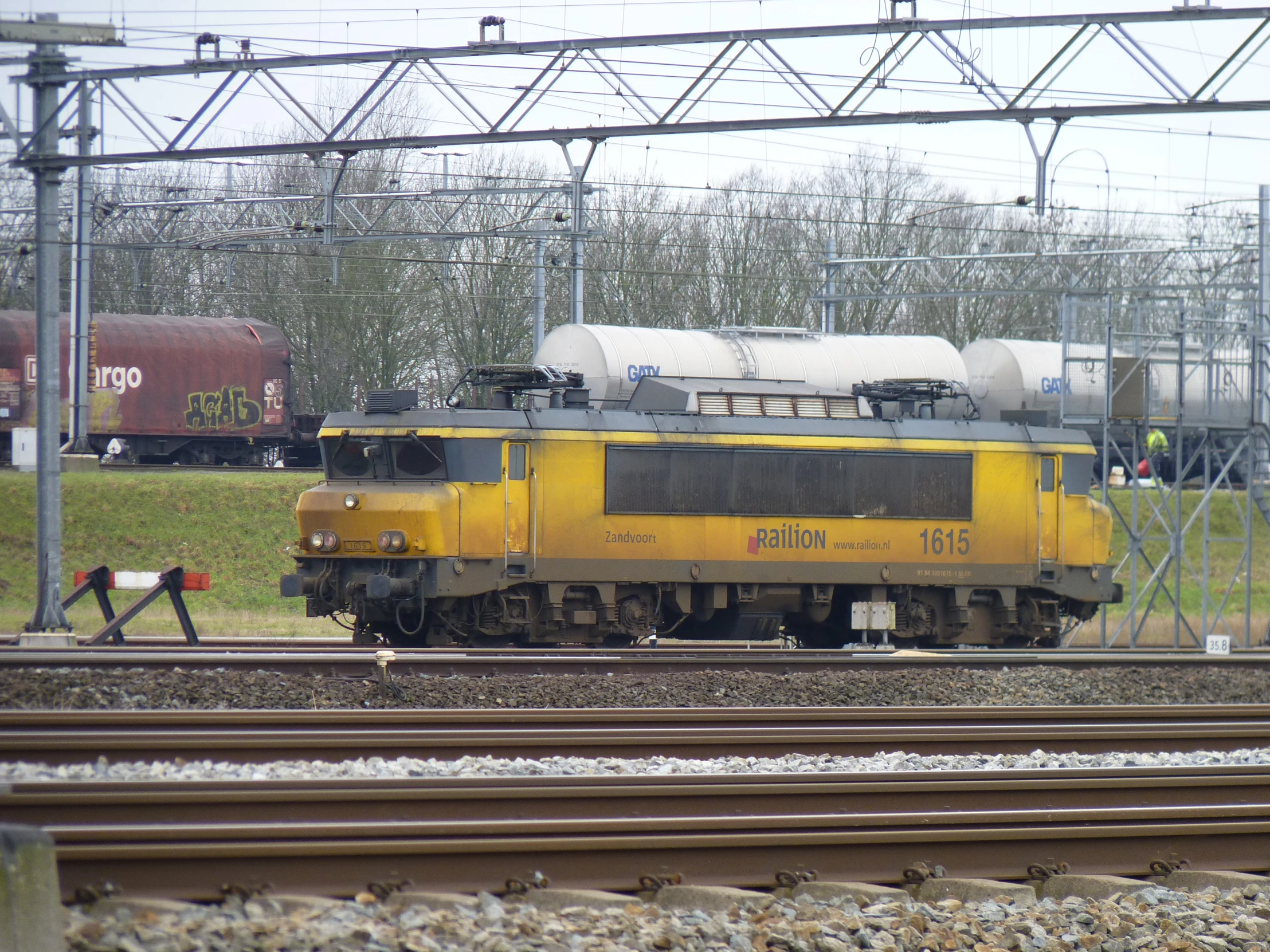 the train is going down the tracks through some power lines