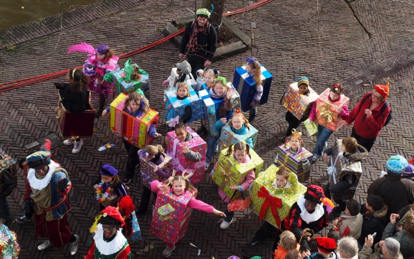 a large group of people stand in a courtyard with some dressed up