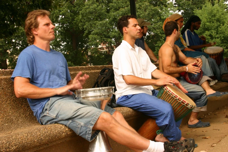 men are playing a musical outside while waiting for soing