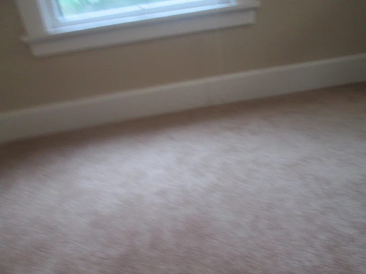 small corner in a home showing floor and window