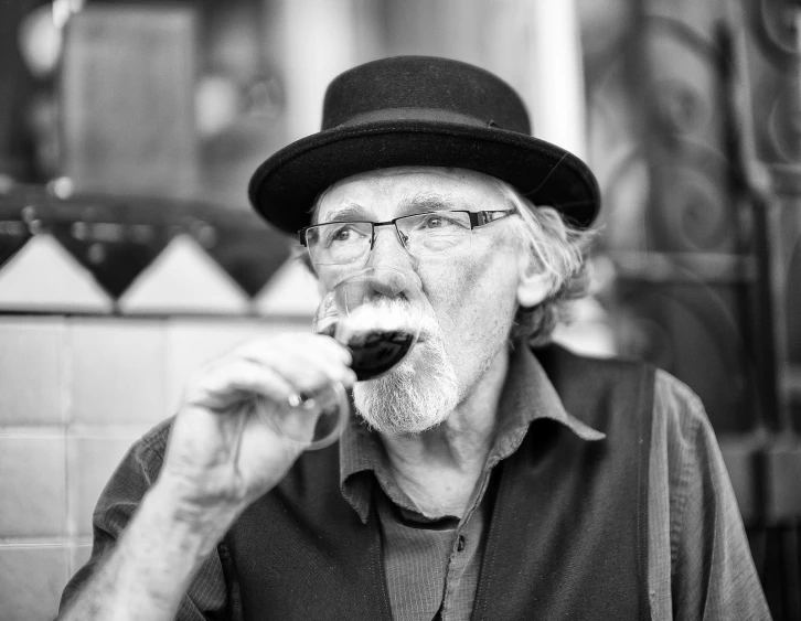 a man with a hat and glasses is eating