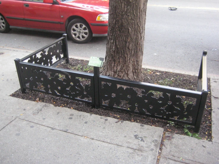 a gate that is in the ground by a tree