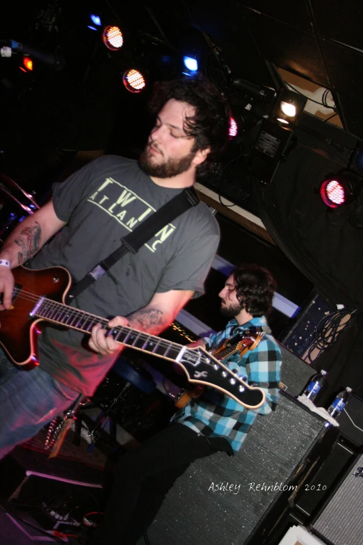 two people in concert playing instruments and an acoustic keyboard