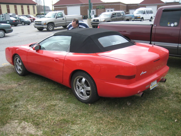 the car is parked on the grass in the parking lot