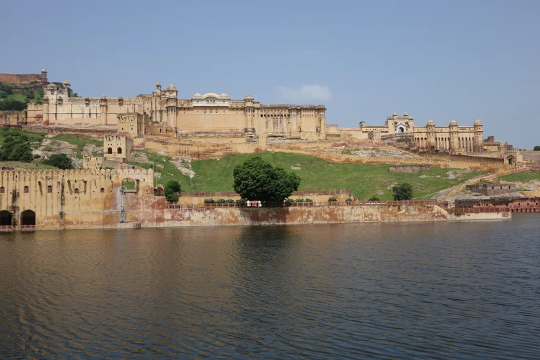 a large castle on top of a hill near the ocean