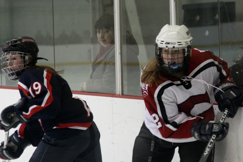 two people playing ice hockey against each other