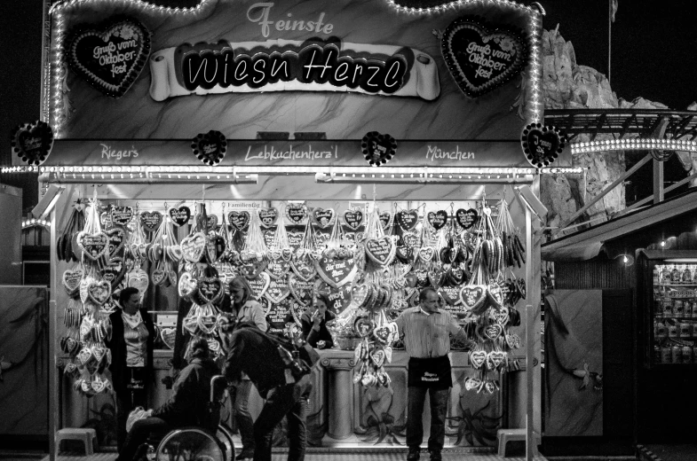 a black and white image of an amut ride with a person standing outside