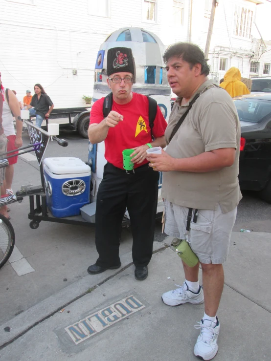 there are two men standing around talking to each other