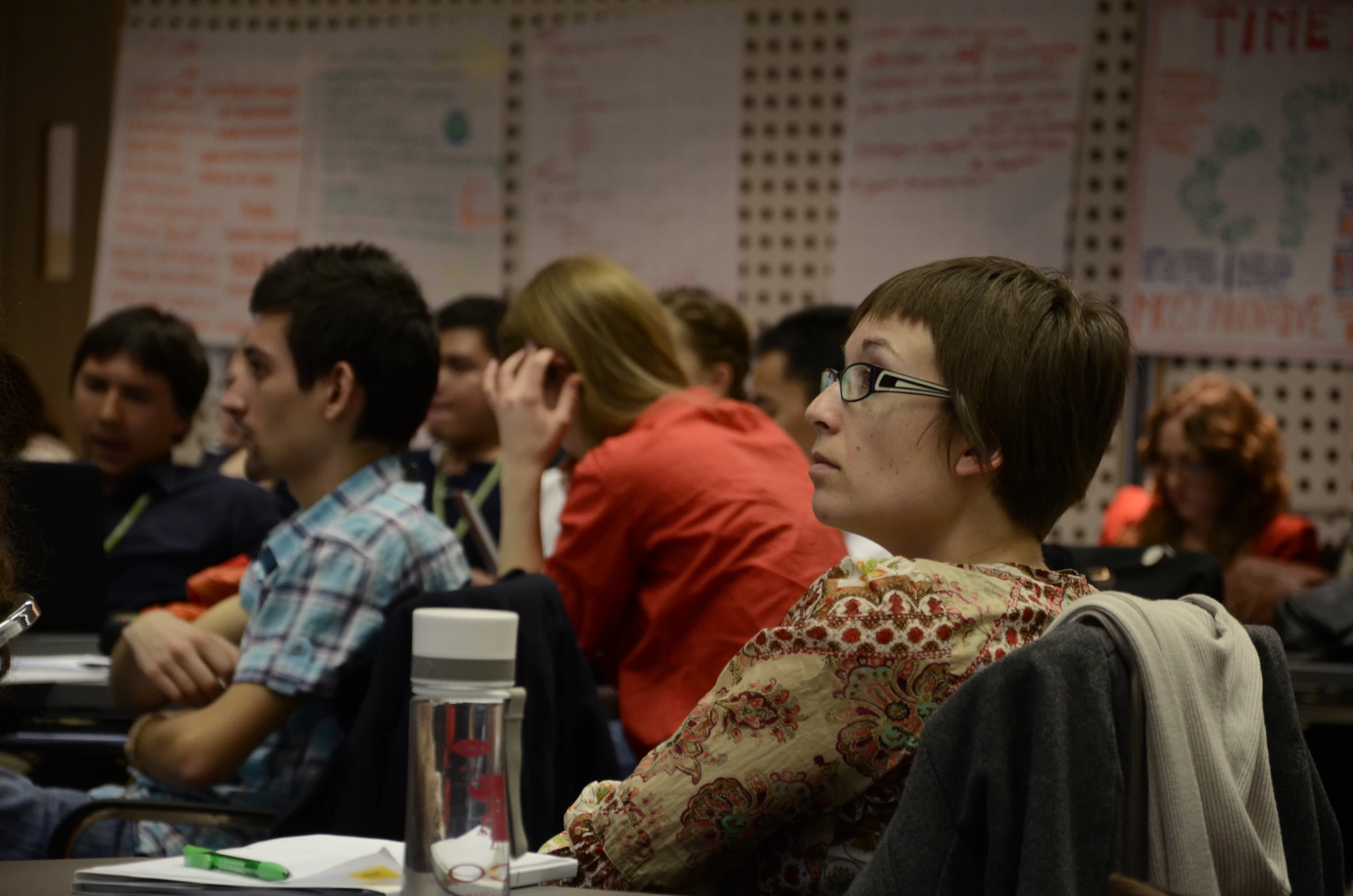 a woman sitting in front of a group of people