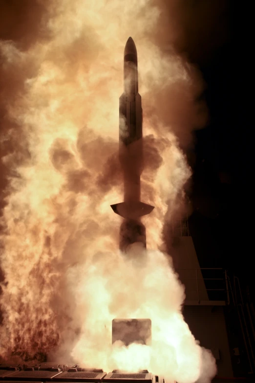 there is smoke coming out of the top of a missile