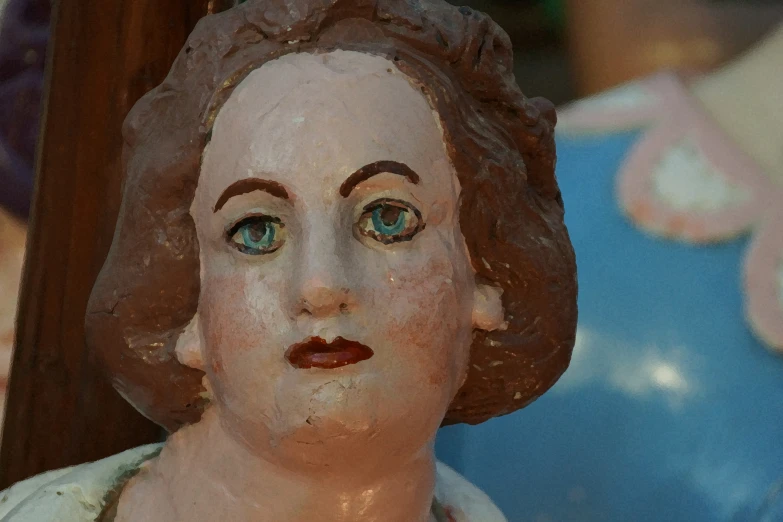 a plaster face in front of blue ceramic balls