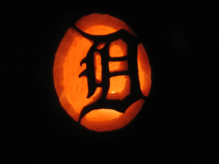 a pumpkin with an iron symbol carved on it