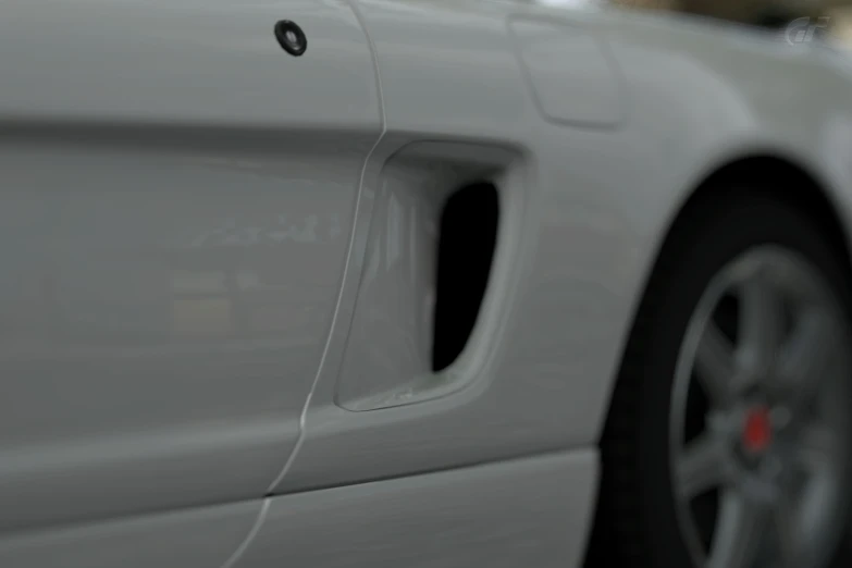 closeup of the front wheel rim and tires of a white sedan