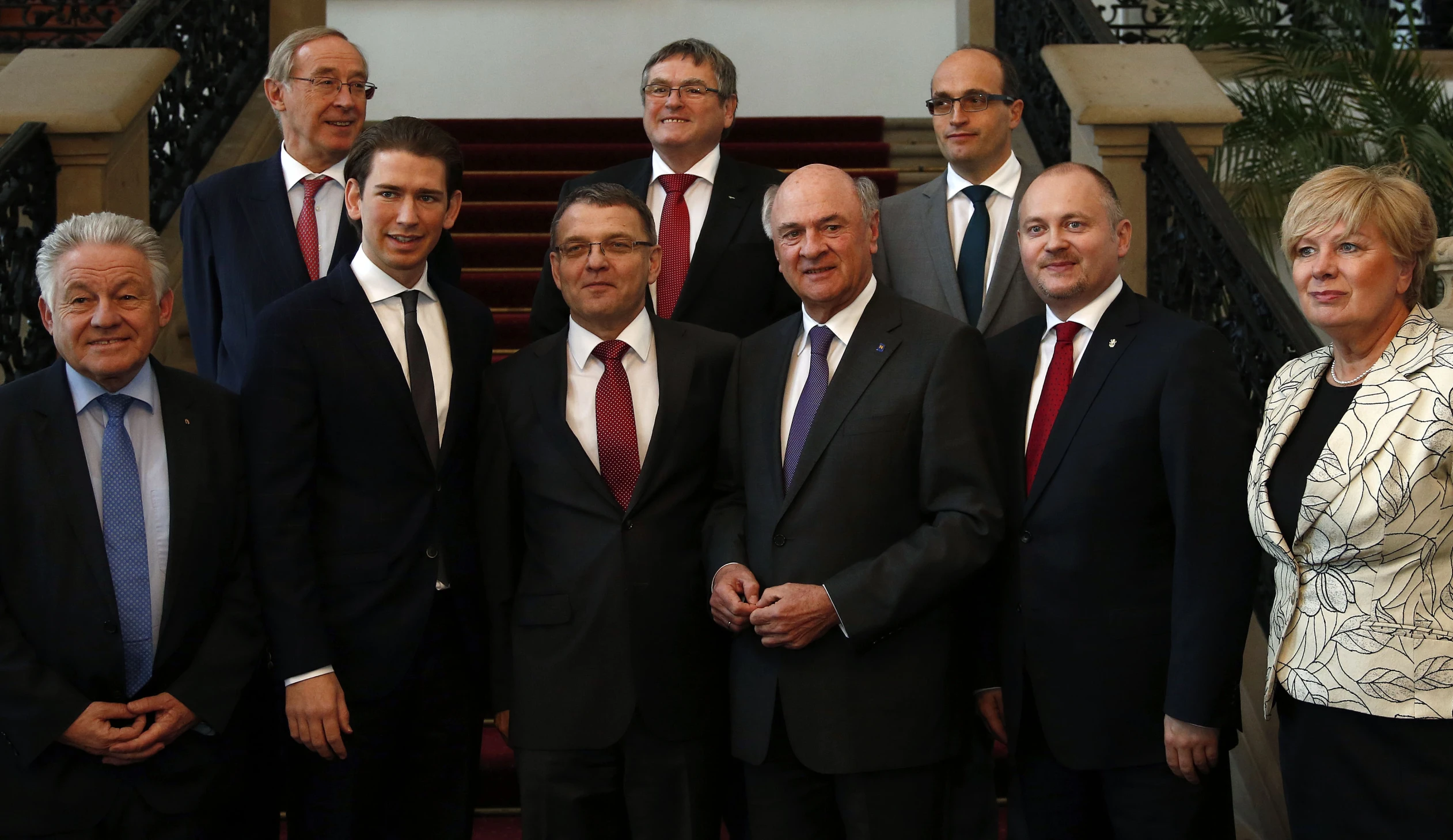 a group of men in suits stand together for a picture