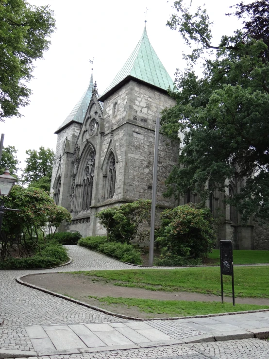 an old church sits in a park with steps leading to it