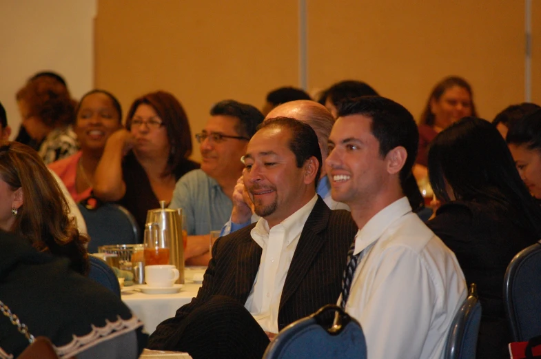 people sitting in rows at a meeting