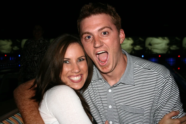 a woman and man posing for a picture